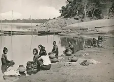 Typical Riverside Scene on the great Irrawaddy - Women bathing and drawing water 1900. Creator: Unknown