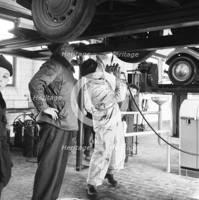 Tyre lubrication of passenger car, Stockholm, Sweden, 1955. Creator: Unknown.