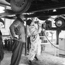 Tyre lubrication of passenger car, Stockholm, Sweden, 1955. Creator: Unknown