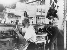 U.S. Naval Gun Factory. Wash. D.C. 2 men working at bench, 1903. Creator: Frances Benjamin Johnston