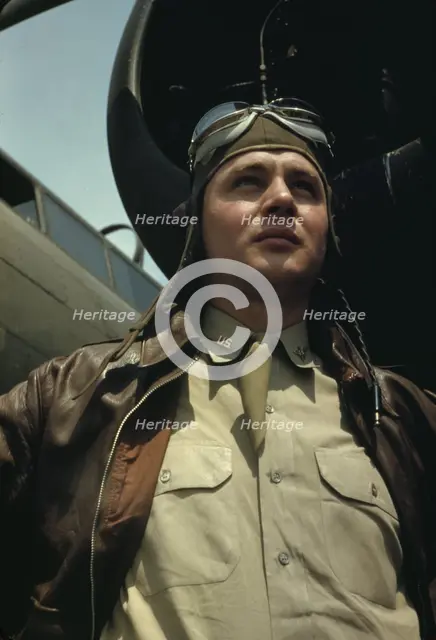 U.S. Army Air Forces pilot in front of a YB-17 bombing..., probably Langley field, Virginia, 1942. Creator: Alfred T Palmer.