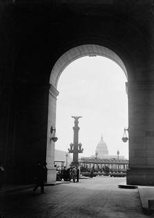 U.S. Capitol - View Through Arch At Union Station, 1917. Creator: Harris & Ewing