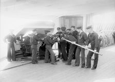 U.S.S. Newark, loading 6-inch gun, between 1891 and 1901. Creator: Unknown