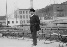 Umberto Blaisie standing in front of park benches, 1910. Creator: Bain News Service