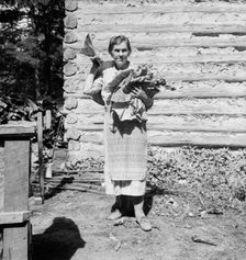 Untitled, 1935-1942. [Woman with tobacco leaves]. Creator: Unknown