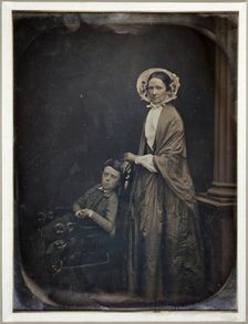 Untitled (A Woman in Bonnet and Shawl, with her Seated Son), c. 1850. Creators: Albert Sands Southworth, Josiah Johnson Hawes