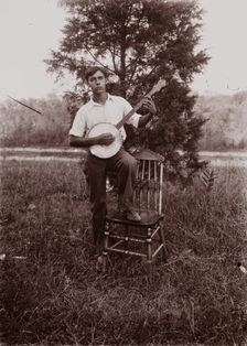 Untitled (man with banjo, neg, #1), c1931, printed c1975. Creator: Wendell Hotter