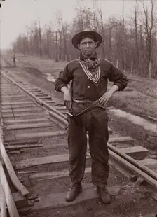 Untitled (man with pistol on railroad tracks, neg. #14), between 1910 and 1935, printed c1975. Creator: Wendell Hotter