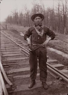 Untitled (man with pistol on railroad tracks, neg. #14), between 1910 and 1935, printed c1975. Creator: Wendell Hotter