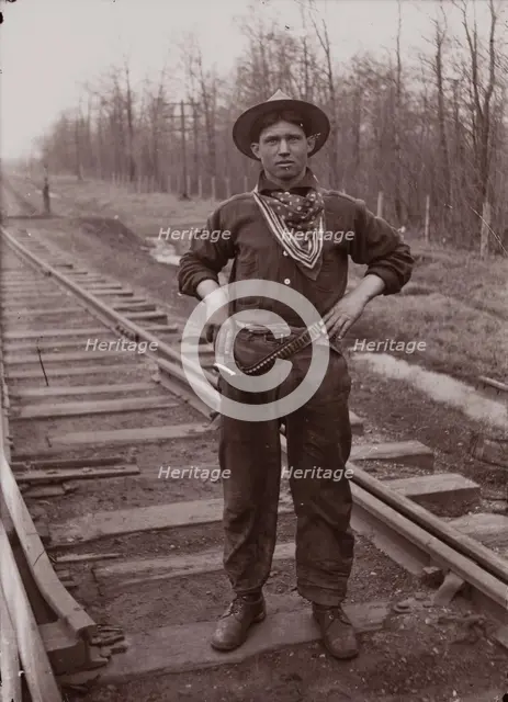 Untitled (man with pistol on railroad tracks, neg. #14), between 1910 and 1935, printed c1975. Creator: Wendell Hotter.