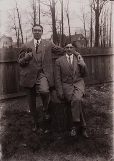 Untitled (two men holding small dog; one sitting on a stump, Fisher St., backyard), c1915. Creator: Wendell Hotter