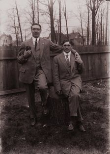 Untitled (two men holding small dog; one sitting on a stump, Fisher St., backyard), c1915. Creator: Wendell Hotter