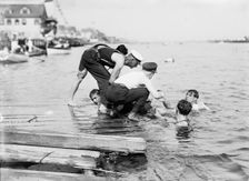 Untying Otto after 45 yd. swim - hands and feet tied, (1910?). Creator: Bain News Service