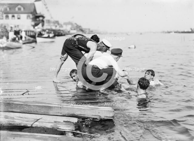Untying Otto after 45 yd. swim - hands and feet tied, (1910?). Creator: Bain News Service.