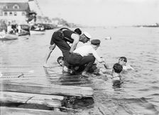 Untying Otto after 45 yd. swim - hands and feet tied, (1910?). Creator: Bain News Service
