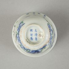 Underglaze blue month cup with polychrome enamelled decoration of a prunus tree
