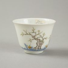 Underglaze blue month cup with polychrome enamelled decoration of a prunus tree