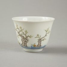 Underglaze blue month cup with polychrome enamelled decoration of a prunus tree