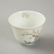 Underglaze blue month cup with polychrome enamelled decoration of a prunus tree