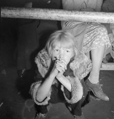 Undernourished cotton picker's child listening to speeches of organizer..., Kern County, CA, 1938. Creator: Dorothea Lange