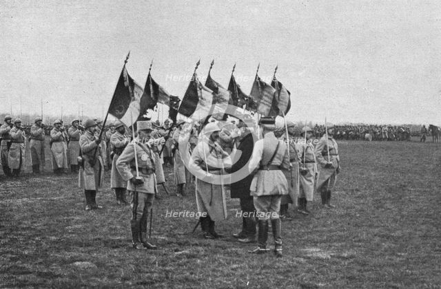 'Une remise de decorationsdevant de glorieux drapeaux don’t plusieurs ont ete laceres..., 1916. Creator: Unknown.