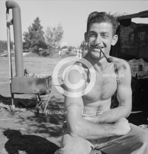 Unemployed lumber worker goes with his wife to the bean harvest, Oregon, 1939. Creator: Dorothea Lange.