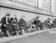 Unemployed men sitting on the sunny side of the San Francisco Public Library, California, 1937. Creator: Dorothea Lange