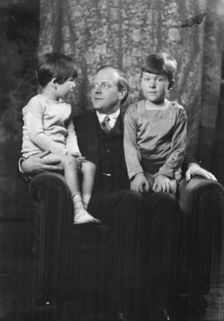 Unidentified man and two children, portrait photograph, between 1911 and 1942. Creator: Arnold Genthe
