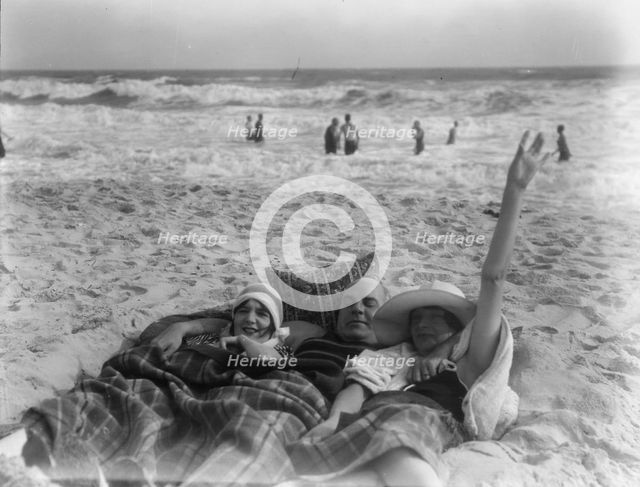 Unidentified man and two women at Long Beach, New York, between 1911 and 1942. Creator: Arnold Genthe.