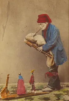 Unidentified man in cap playing a bagpipe-type instrument with two marionettes, about 1870. Creator: Giorgio Conrad