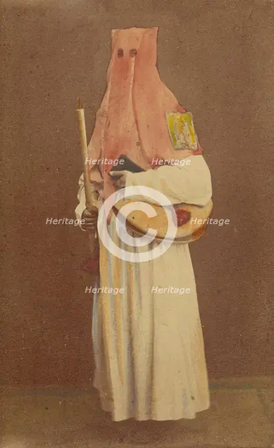Unidentified man in long hood holding a candle and book, standing, about 1870. Creator: Giorgio Conrad.
