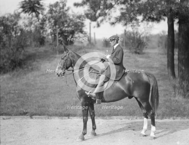 Unidentified man riding Chesty, between 1911 and 1936. Creator: Arnold Genthe.