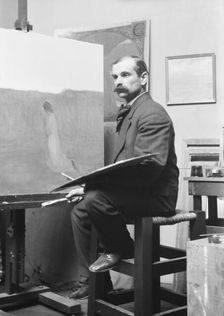 Unidentified man, seated at his easel, portrait photograph, between 1896 and 1942. Creator: Arnold Genthe