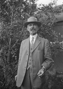 Unidentified man, standing outdoors, between 1896 and 1942. Creator: Arnold Genthe
