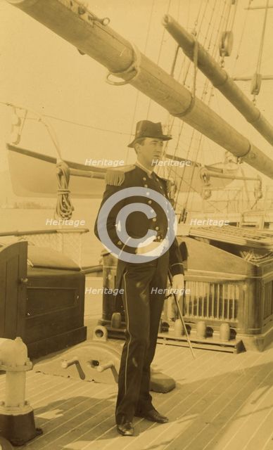 Unidentified naval officer, full-length portrait, standing aboard ship, facing right, 1894 or 1895. Creator: Alfred Lee Broadbent.