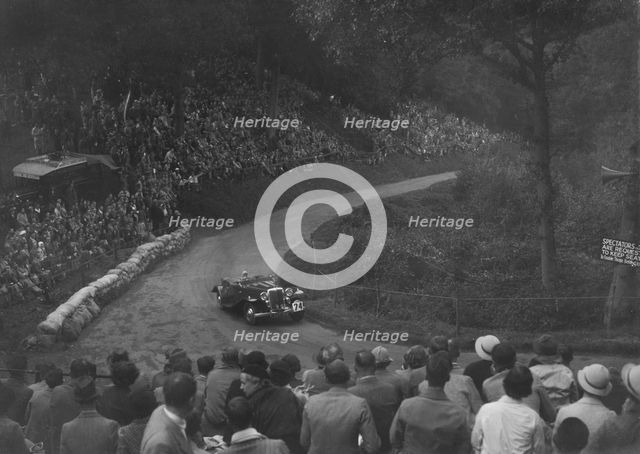 Unidentified open 4-seater car competing in the Shelsley Walsh Hillclimb, Worcestershire, 1935. Artist: Bill Brunell.