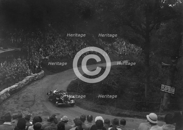 Unidentified open 4-seater car competing in the Shelsley Walsh Hillclimb, Worcestershire, 1935. Artist: Bill Brunell.