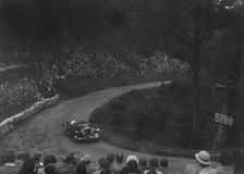 Unidentified open 4-seater car competing in the Shelsley Walsh Hillclimb, Worcestershire, 1935. Artist: Bill Brunell