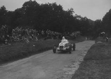 Unidentified open single-seater car competing in the Shelsley Walsh Hillclimb, Worcestershire, 1935. Artist: Bill Brunell