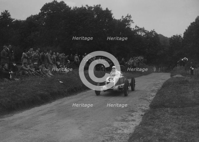 Unidentified open single-seater car competing in the Shelsley Walsh Hillclimb, Worcestershire, 1935. Artist: Bill Brunell.
