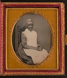 Unidentified African American woman in headscarf and apron, between 1850 and 1870. Creator: Unknown