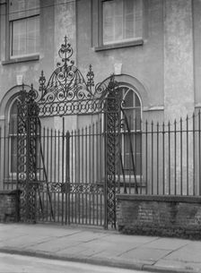 Unidentified building behind a fence, New Orleans or Charleston, South Carolina, c1920-1926. Creator: Arnold Genthe