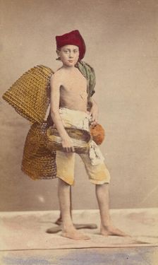Unidentified boy wearing native costume with baskets on back and carrying a water jug..., 1870-1875. Creator: Giorgio Conrad