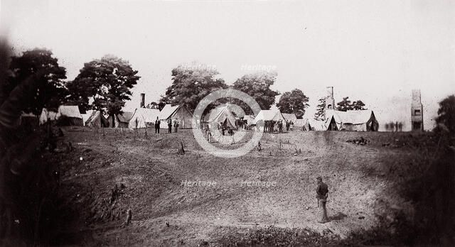 [Unidentified camp with ruined chimneys in background]. Brady album, p. 130, 1861-65. Creator: Unknown.