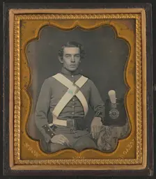 Unidentified soldier of 7th New York Infantry Regiment in uniform graphic /, between 1861 and 1863. Creator: Rufus Anson