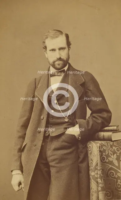 Unidentified well-dressed bearded man standing, elbow on books on a table, 1865-1870. Creator: Bayard & Bertall.