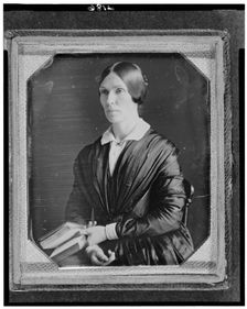 Unidentified woman, half-length portrait, facing left, seated holding book, between 1846 and 1856. Creator: Marcus Aurelius Root