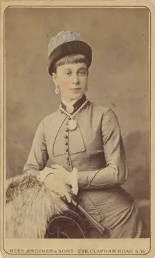 Unidentified woman standing, holding a fan, 1879. Creator: David Rees & Brother & Son