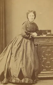 Unidentified woman standing, leaning against a credenza, about 1861. Creator: Bayard & Bertall