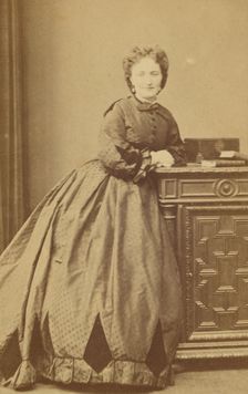 Unidentified woman standing, leaning against a credenza, about 1861. Creator: Bayard & Bertall